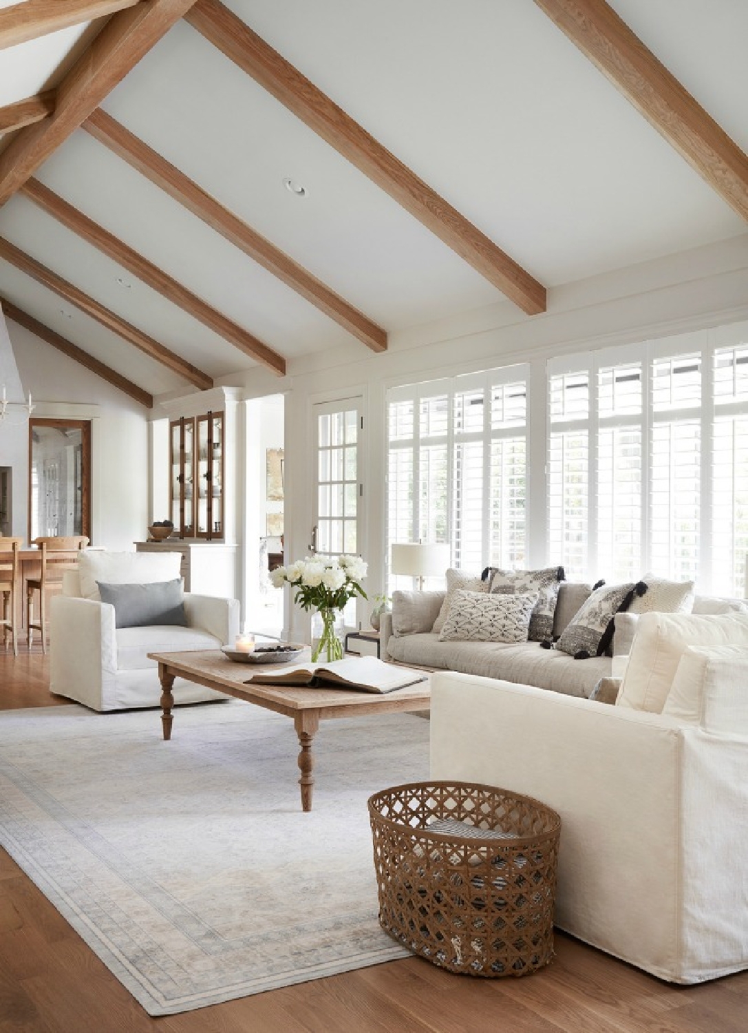 Living Room Set with Exposed Wood Beams and White Interior Shutters