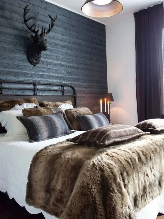 Metal Bed Frame in Rustic Room with Faux Taxidermy Stag Head