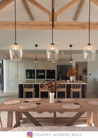 Pendant Light featuring bell shaped glass for wood trusses