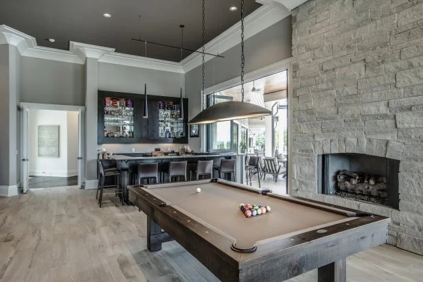 Recreation Room featuring a Stone Surround for Luxury Basement Bar Ideas