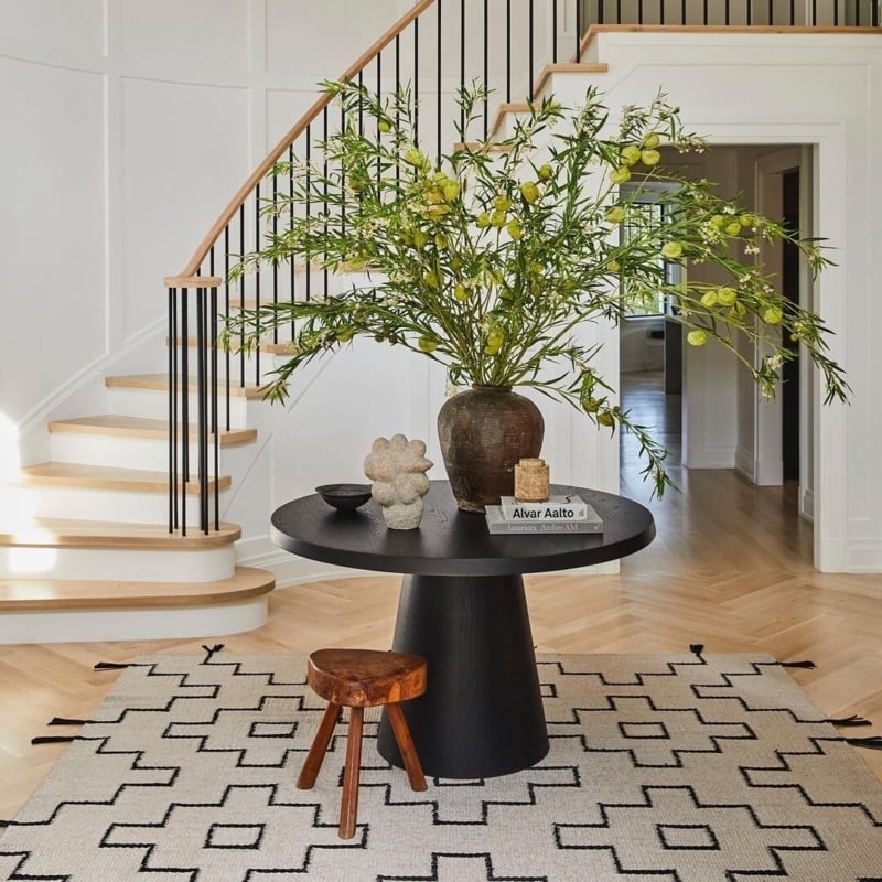 Round Entryway Table In Matte Black With Geometric Rug