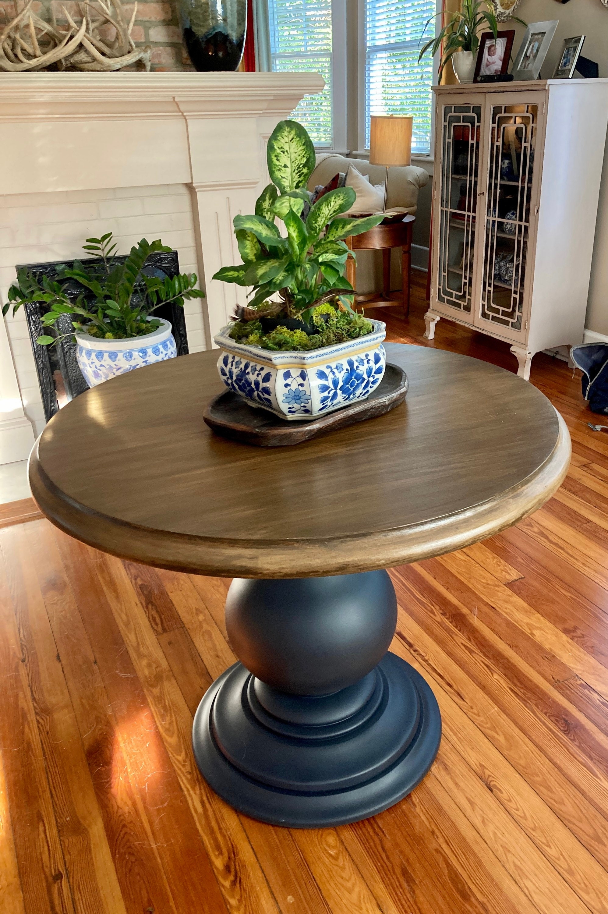 Round Pedestal Table Featuring Spherical Base And Two-Tone