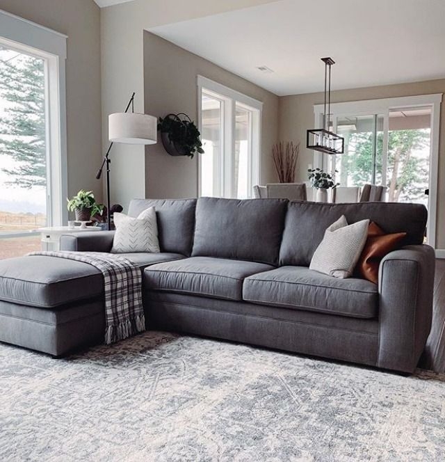 Sectional Sofa with Distressed Rug and Arched Floor Lamp