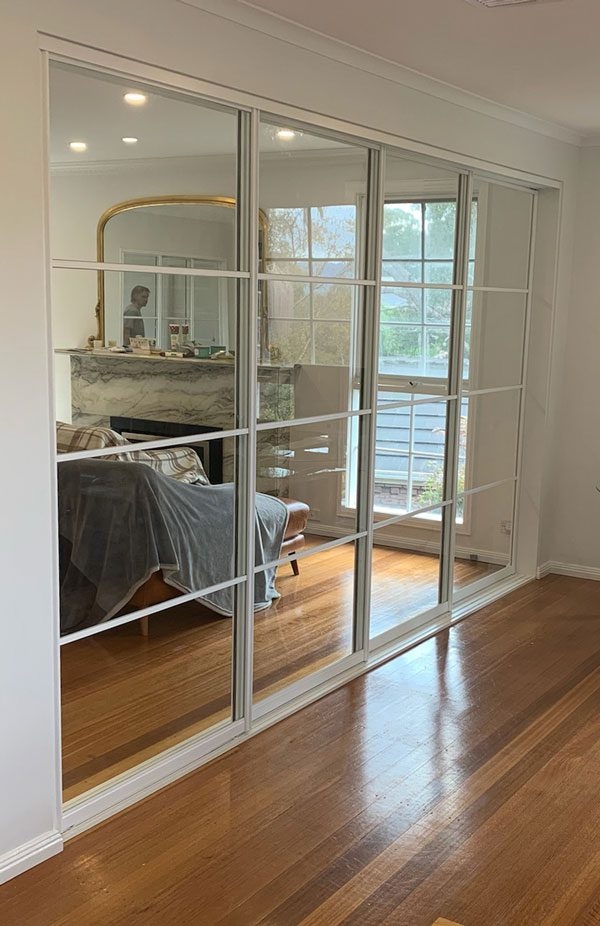 Sliding Room Divider: White Grid Muntins Triple Track Glass Wall
