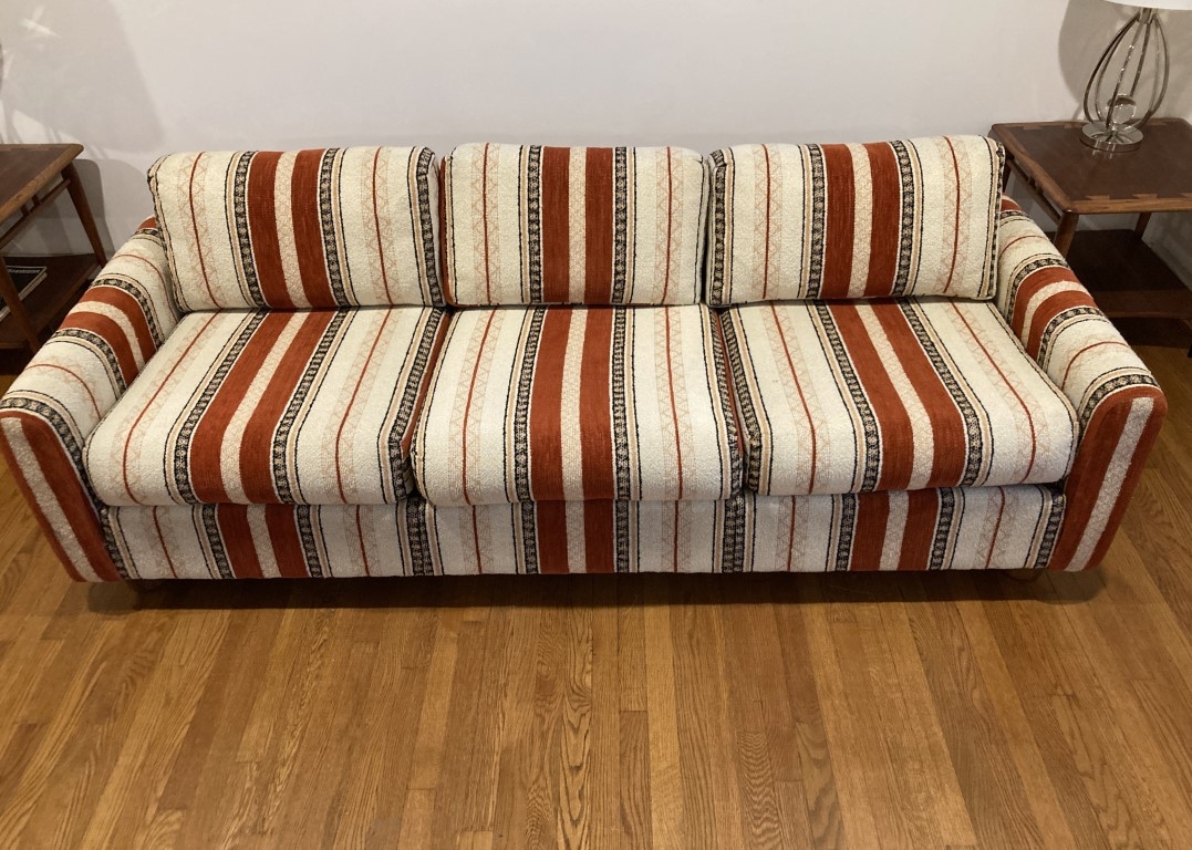 Sofa Featuring Bold Vertical Stripes and Orange Cream Palette