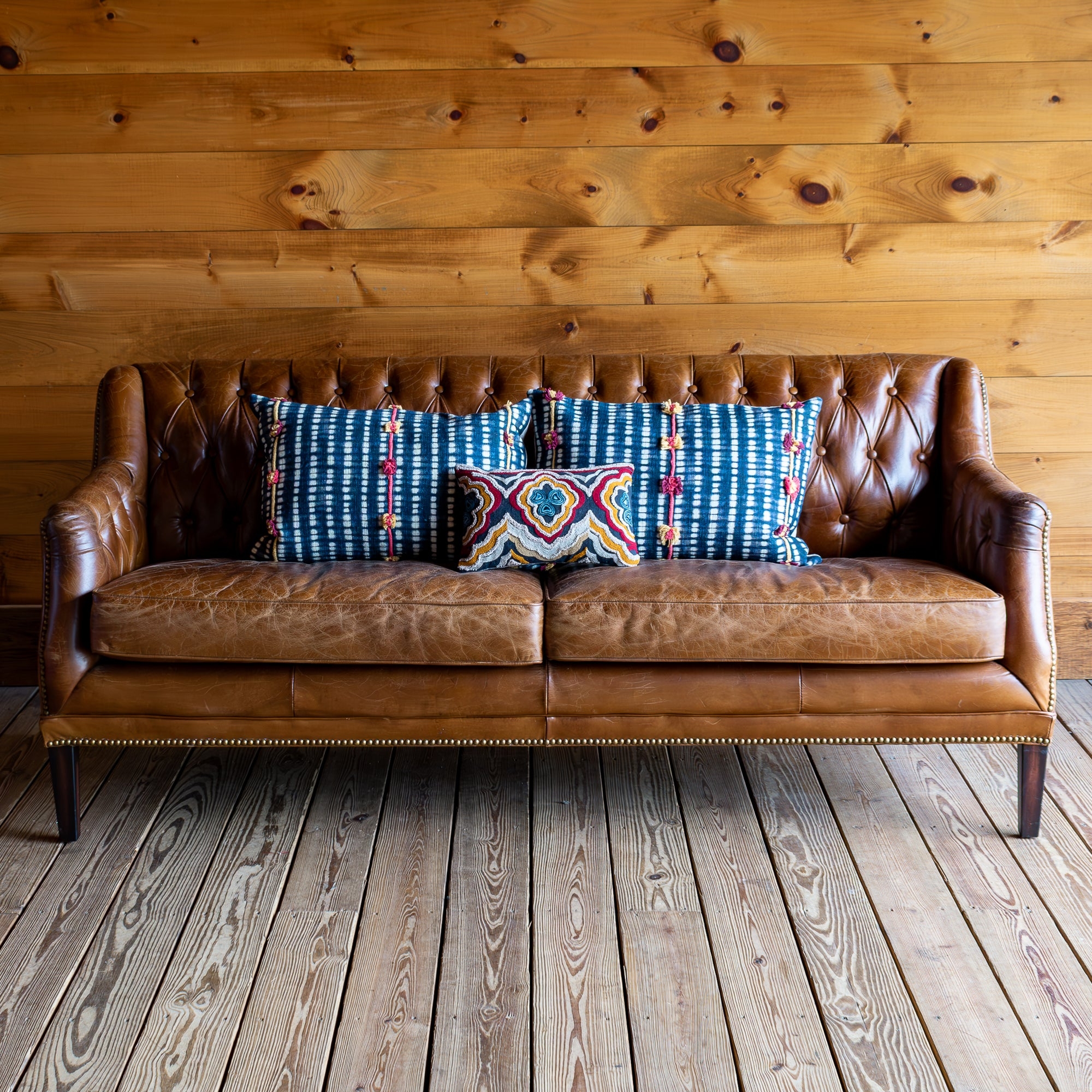 Tufted Sofa Featuring Button Tufting and Rustic Lodge Style