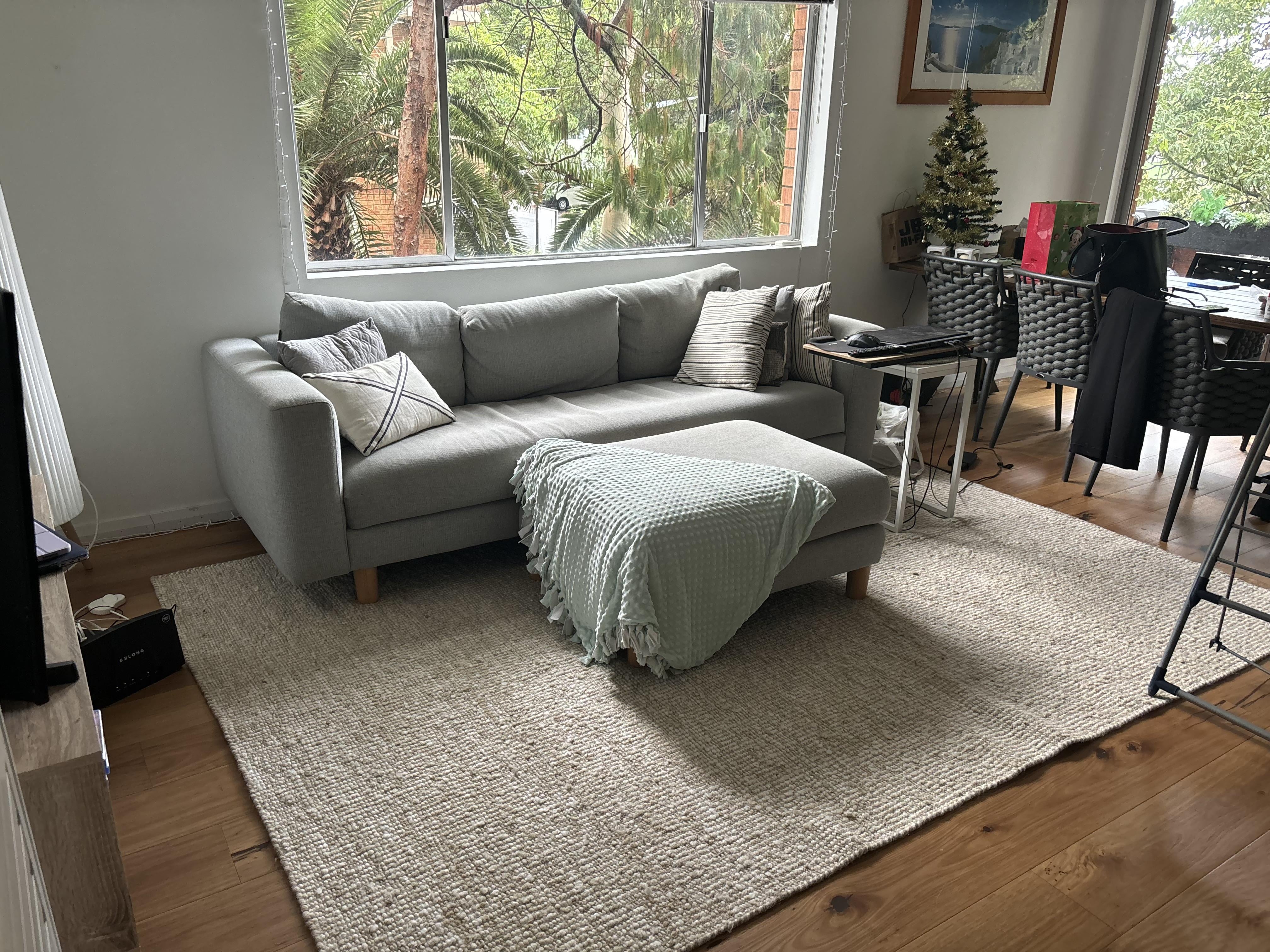 Upholstered Sofa with Waffle Knit Throw and Chunky Beige Rug