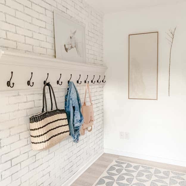 Wall Mounted Hook Rack on Whitewashed Brick with Crown Molding Shelf