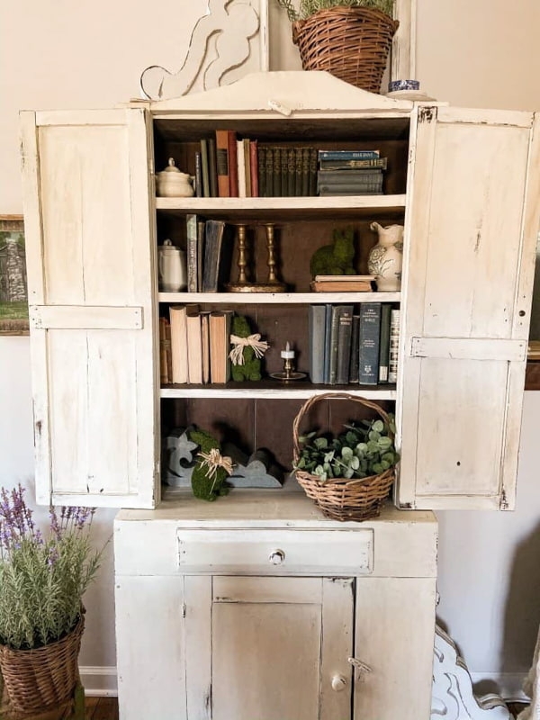 Antique Cabinet with Whitewashed Finish and Dark Interior Decor
