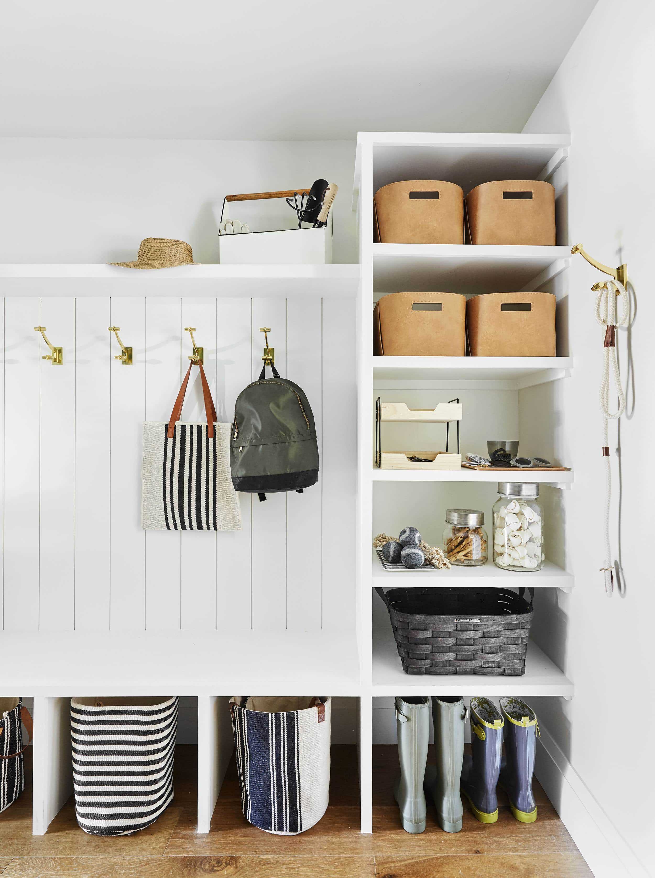 Built In Mudroom Featuring Cognac Bins and Brass Hooks