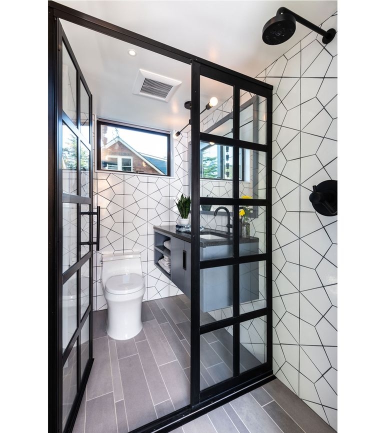 Compact Bathroom with Grid Glass Enclosure and Geometric Tile