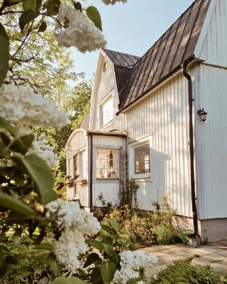 Farmhouse Exterior Blooming Lilac Framing: white scandinavian farmhouse.