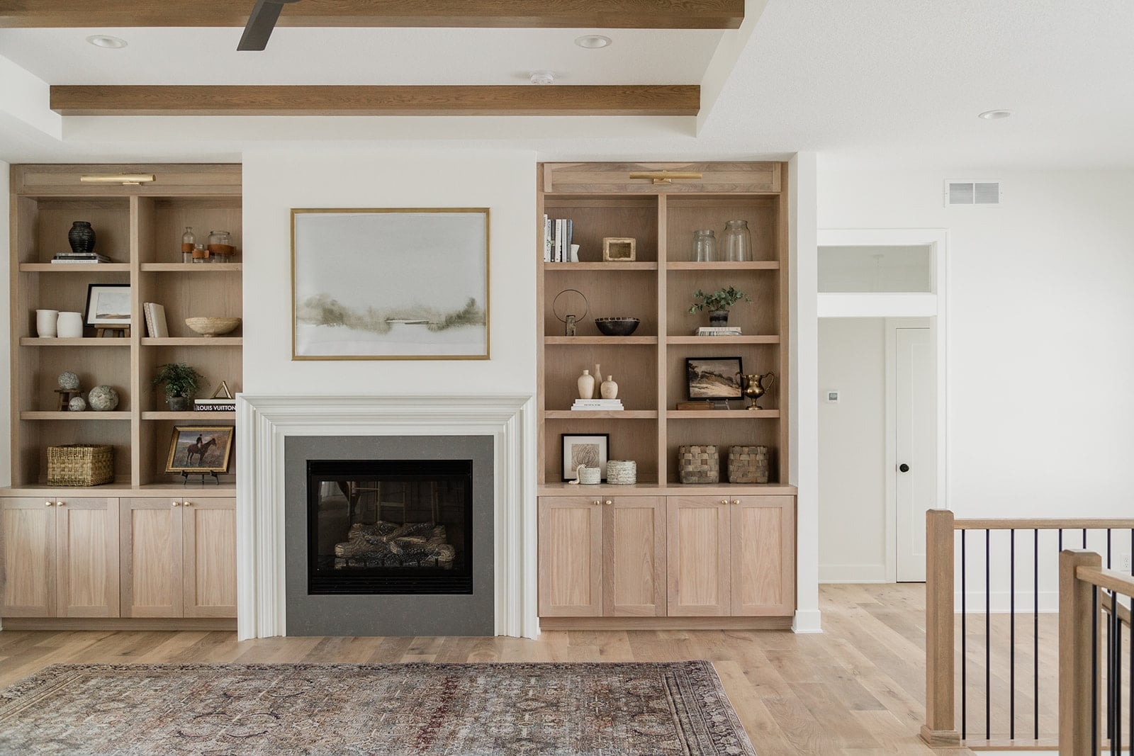 Fireplace Built-Ins with Symmetric Oak Shelving and Picture Lights