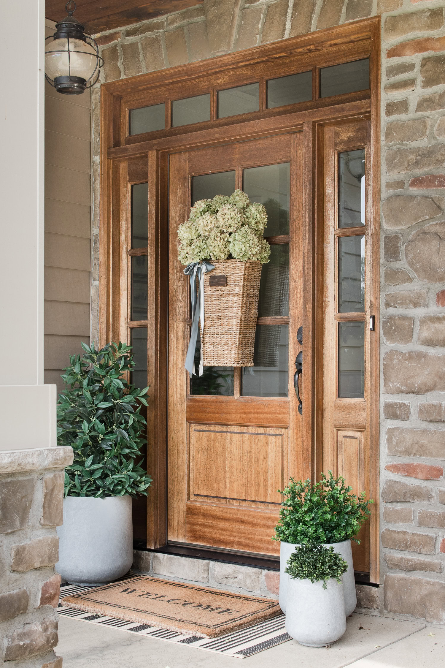 Front Door Set in Wood With Sidelights and Layered Doormat Styling