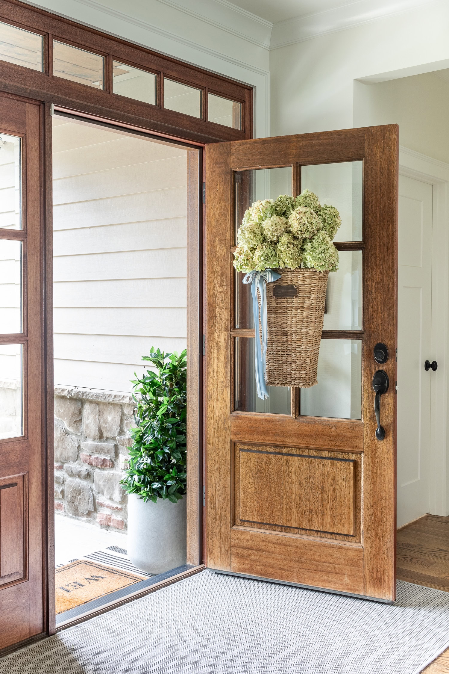 Front Door with Six Pane Glass and Woven Rattan Entryway Decor