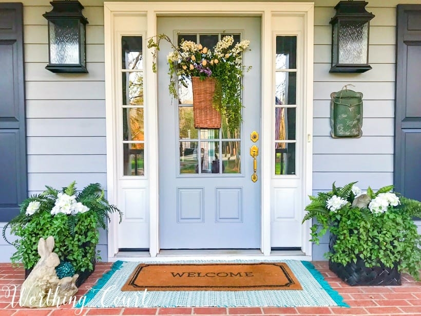 Front Entryway Featuring Powder Blue Door Decor and Layered Rugs