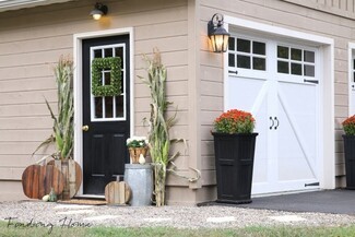 Garage Entry Farmhouse Makeover with Corn Stalks and Wooden Pumpkins