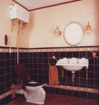 High Tank Toilet showcases Shell Motif Ceramic and Antique Gold Hardware