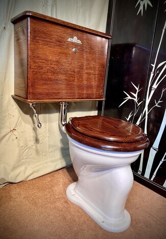 High Tank Toilet with Wood Toned Cistern and Restored Victorian Style