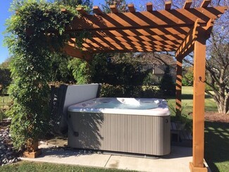 Hot Tub with Climbing Vine Privacy and Slatted Wood Roof
