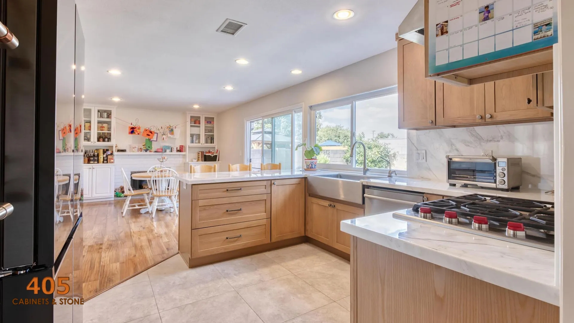 Kitchen Cabinetry: Honey Wood Grain Open Concept Layout