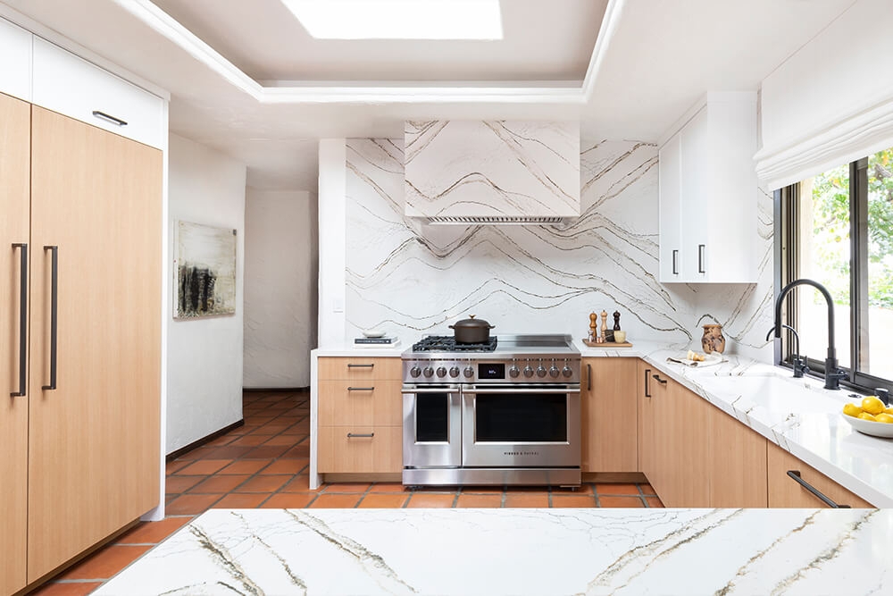 Kitchen Cabinetry: Stone Wrapped Hood Terracotta Floor
