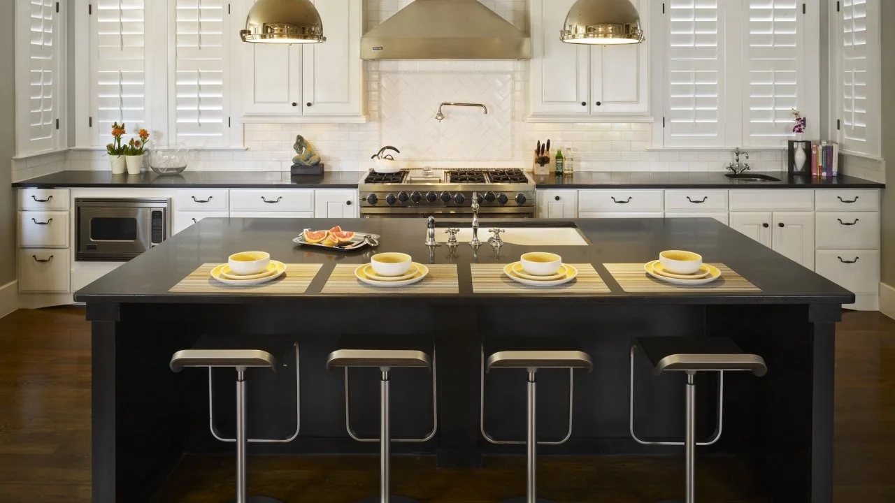 Kitchen Island Features Matte Black Surface and Silver Dome Lighting