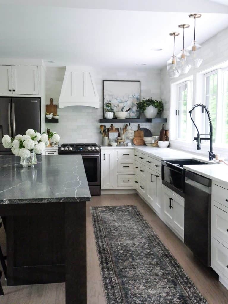 Kitchen Island Featuring Veined Stone Surface and Vintage Runner Rug