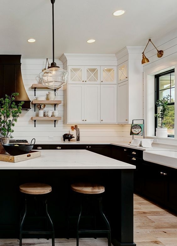 Kitchen Island in a Black and White Farmhouse Kitchen with Sconces