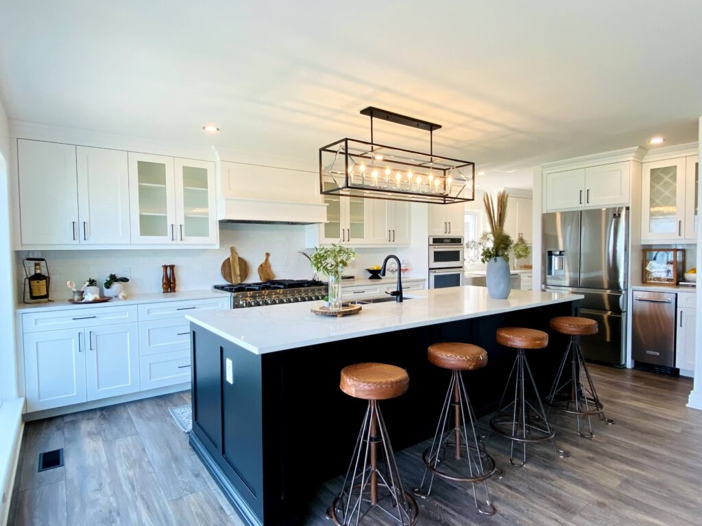 Kitchen Island with Linear Lantern Fixture and Tripod Bar Stools