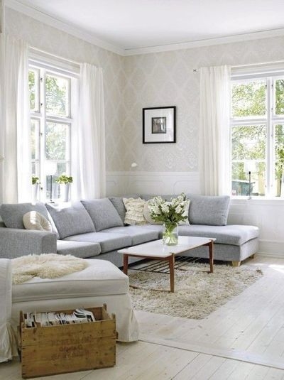 L-Shaped Sectional: Taupe Damask Wallpaper and Wood Floors