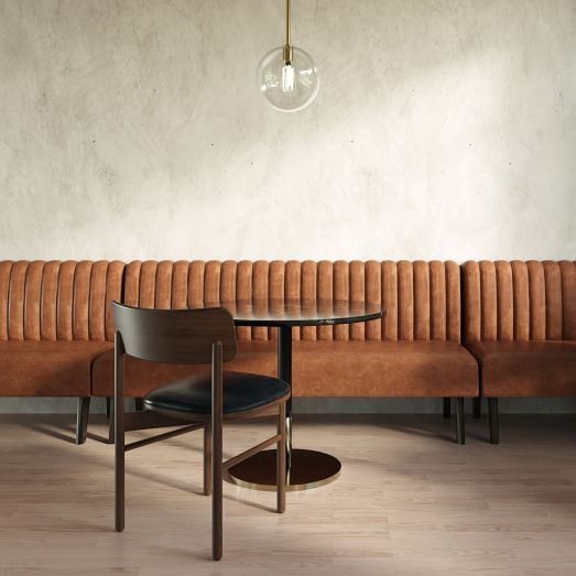 Leather Banquette featuring Vertical Channel Tufting and Pedestal Table