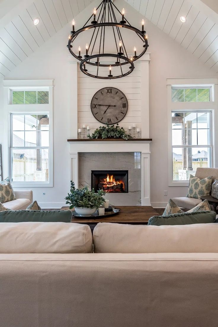 Living Room with Two-Tier Chandelier and Large Clock