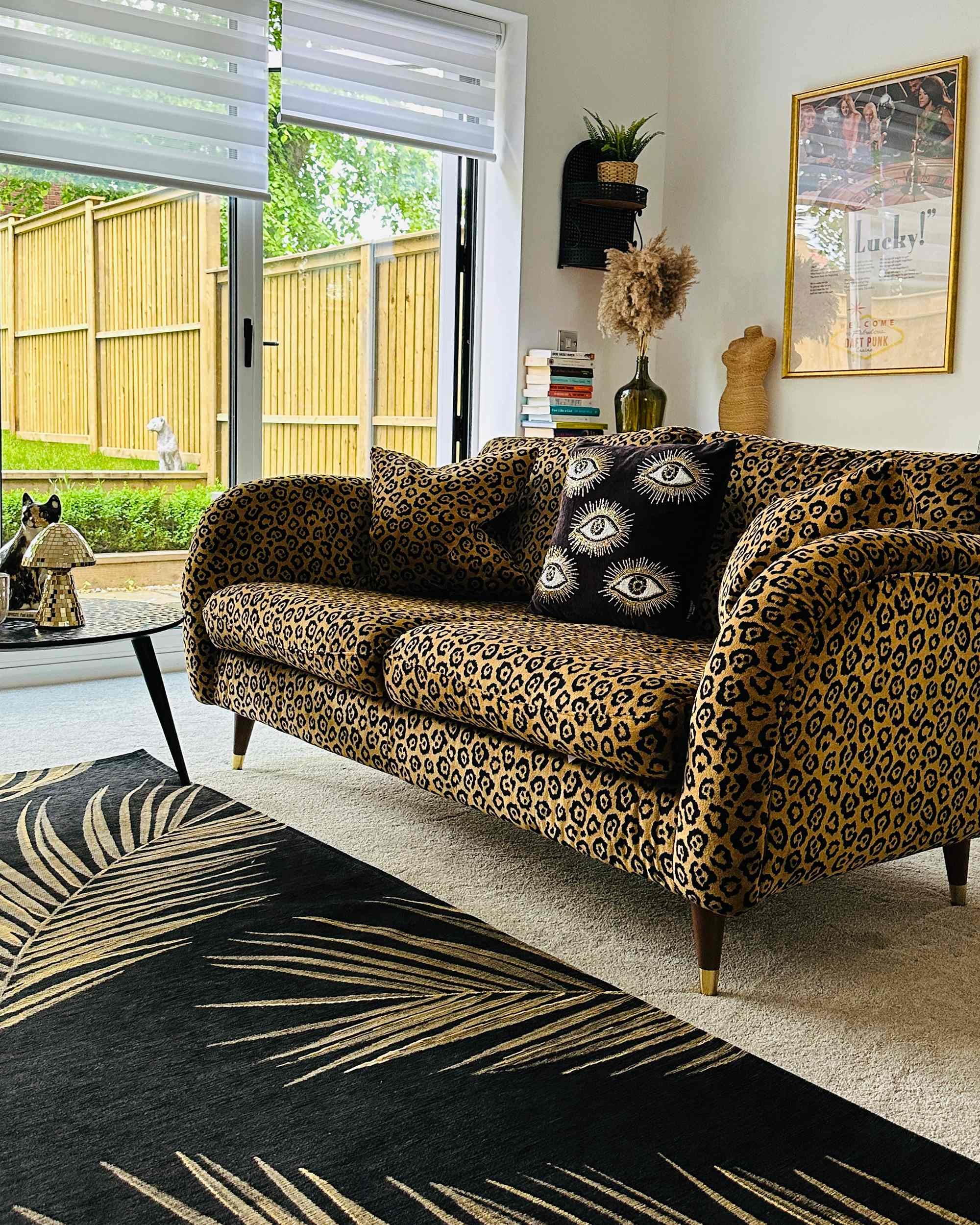 Loveseat with Tapered Gold Capped Legs and Palm Leaf Decor