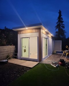 Modern Shed featuring Recessed Soffit Lighting and Flat Roof