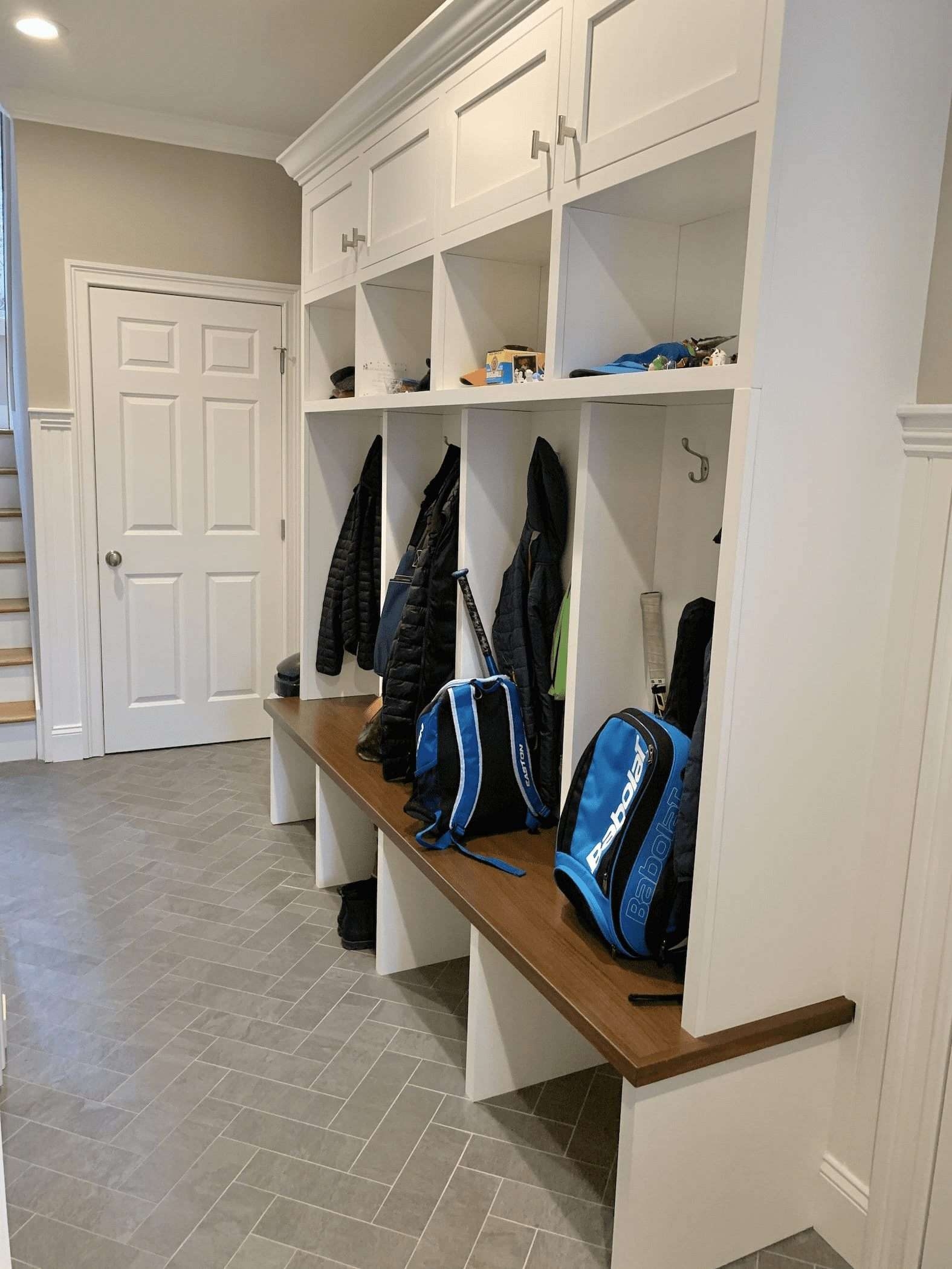 Mudroom Bench Cabinetry: White Shaker and Herringbone Tile Floor