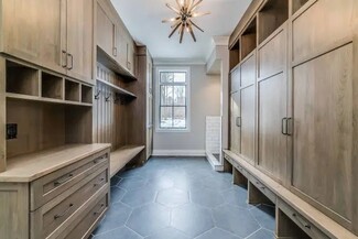 Mudroom Cabinetry: Hexagonal Slate Floor and Wood Built-Ins
