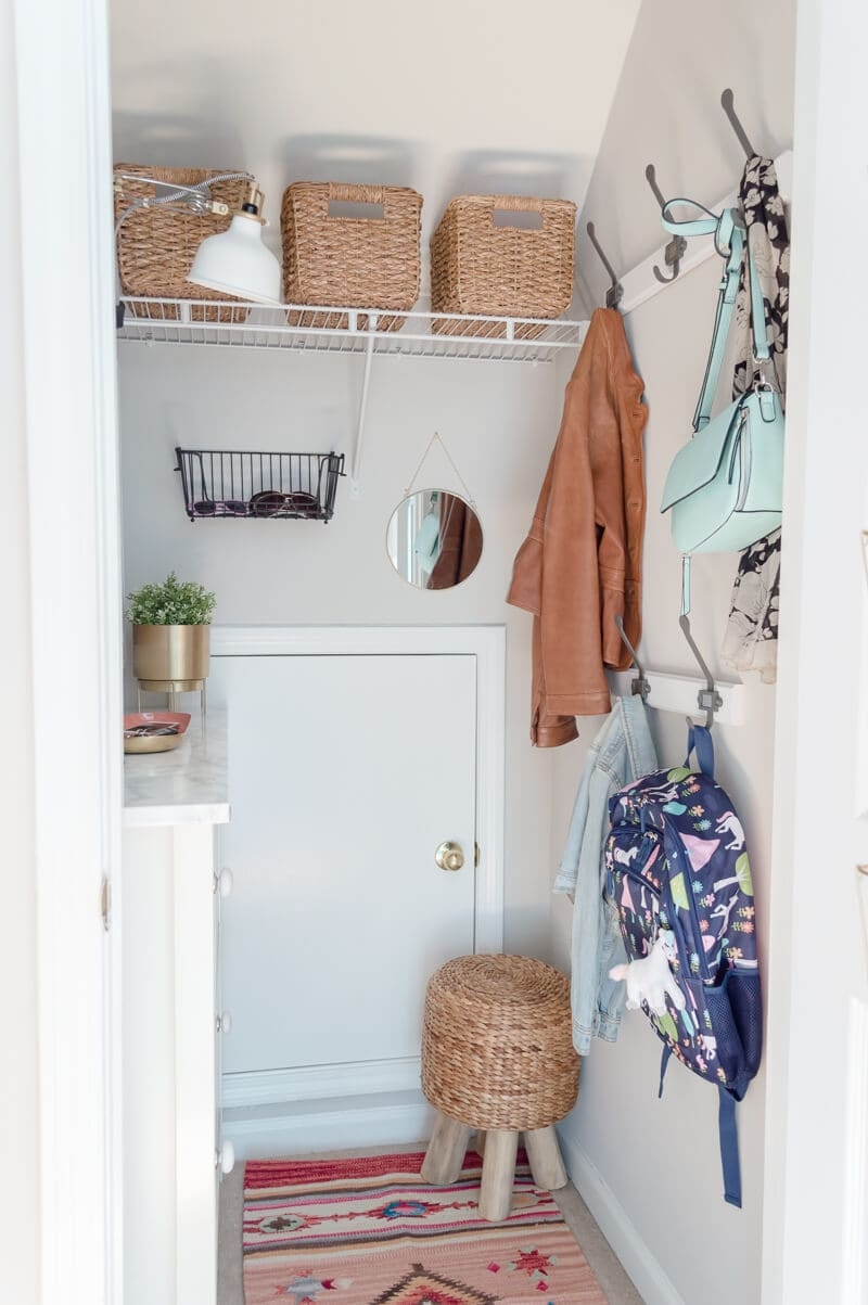 Mudroom Closet with Round Mirror and Rattan Textures