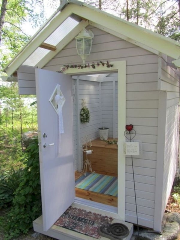 Outdoor Bathroom Shed with Pale Lavender Siding and Skylight