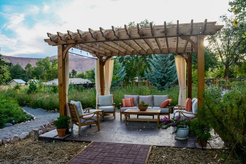 Outdoor Pergola Seating Area with Privacy Curtains and Lights