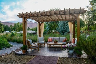 Outdoor Pergola Seating Area with Privacy Curtains and Lights