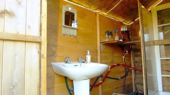 Pedestal Sink with Exposed Plumbing and LED Strip Lighting