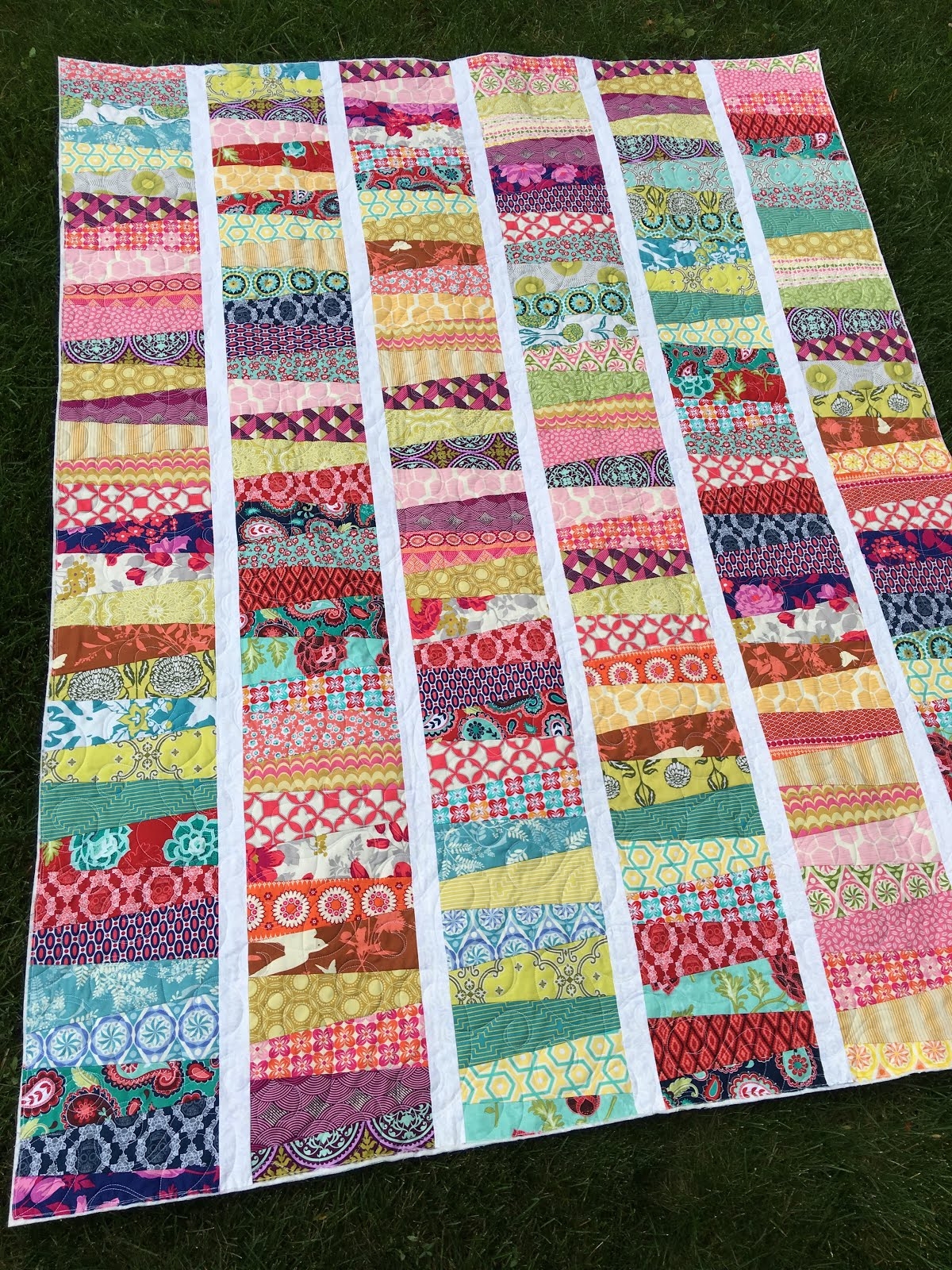 Quilt with Angled Strip Piecing and White Sashing Detail