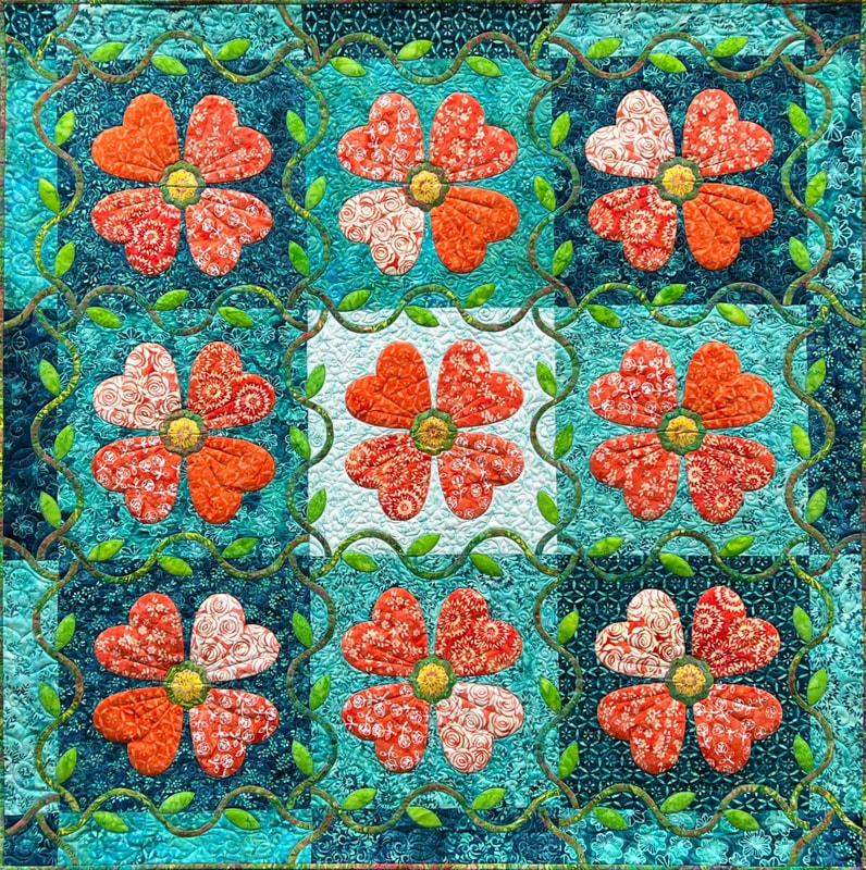 Quilt with Heart Shaped Petals and Vine Applique Border