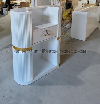 Reception Desk Featuring Fluted Paneling and Gold Trim