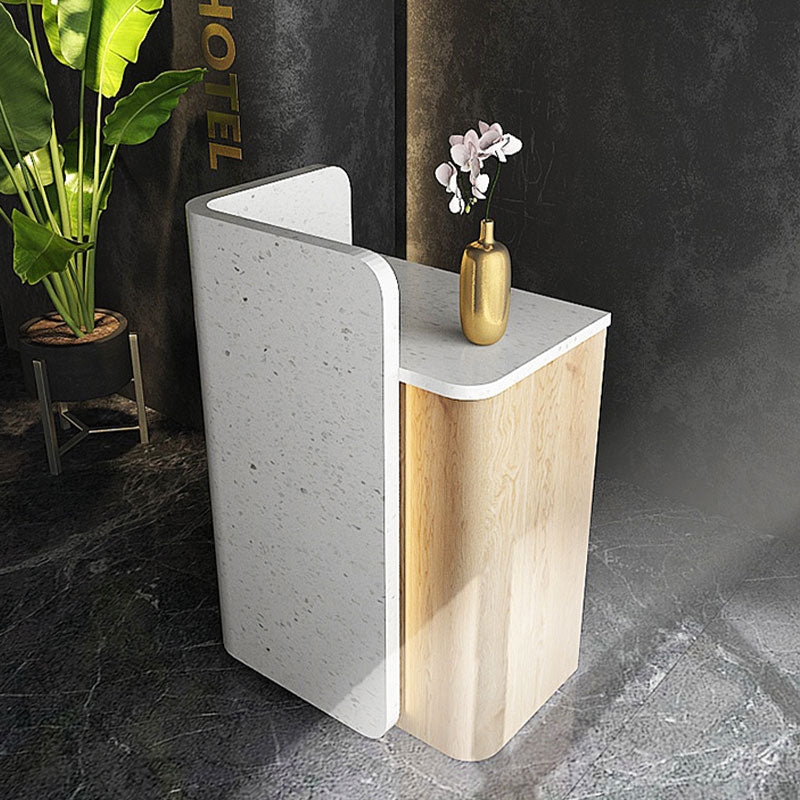 Reception Desk Featuring L-Shaped Wrap and Speckled Panel