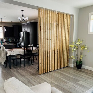 Room Divider: Spaced Vertical Slat Wall for Open Concept Homes
