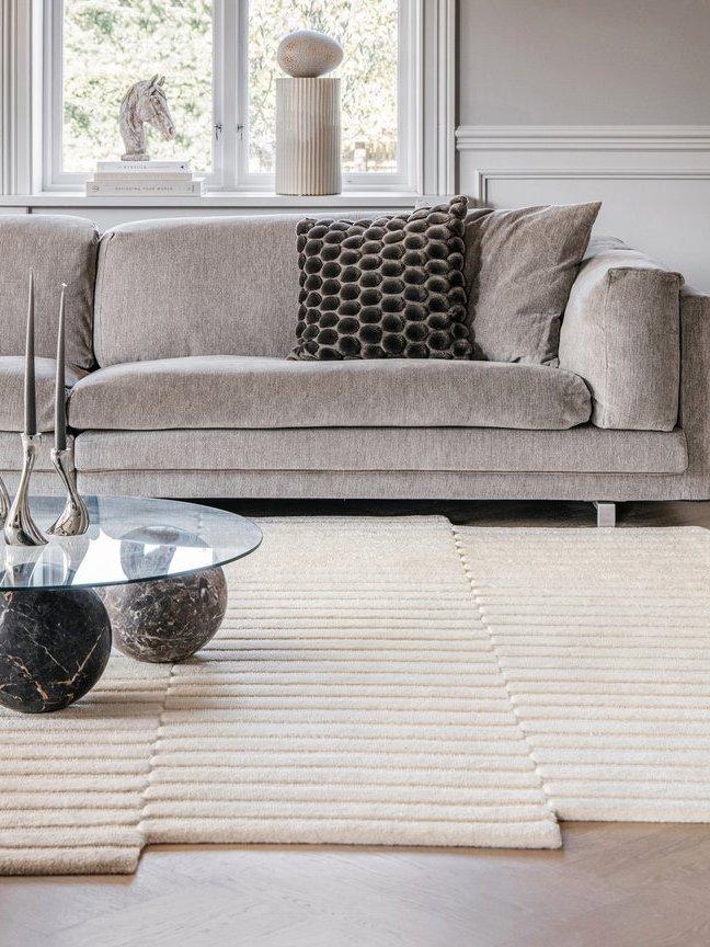 Sectional Sofa: Ribbed Cream Area Rug and Marble Spheres