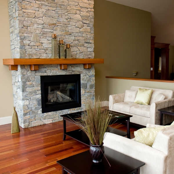 Stacked Stone Fireplace Olive Accent Wall and Walnut Mantel