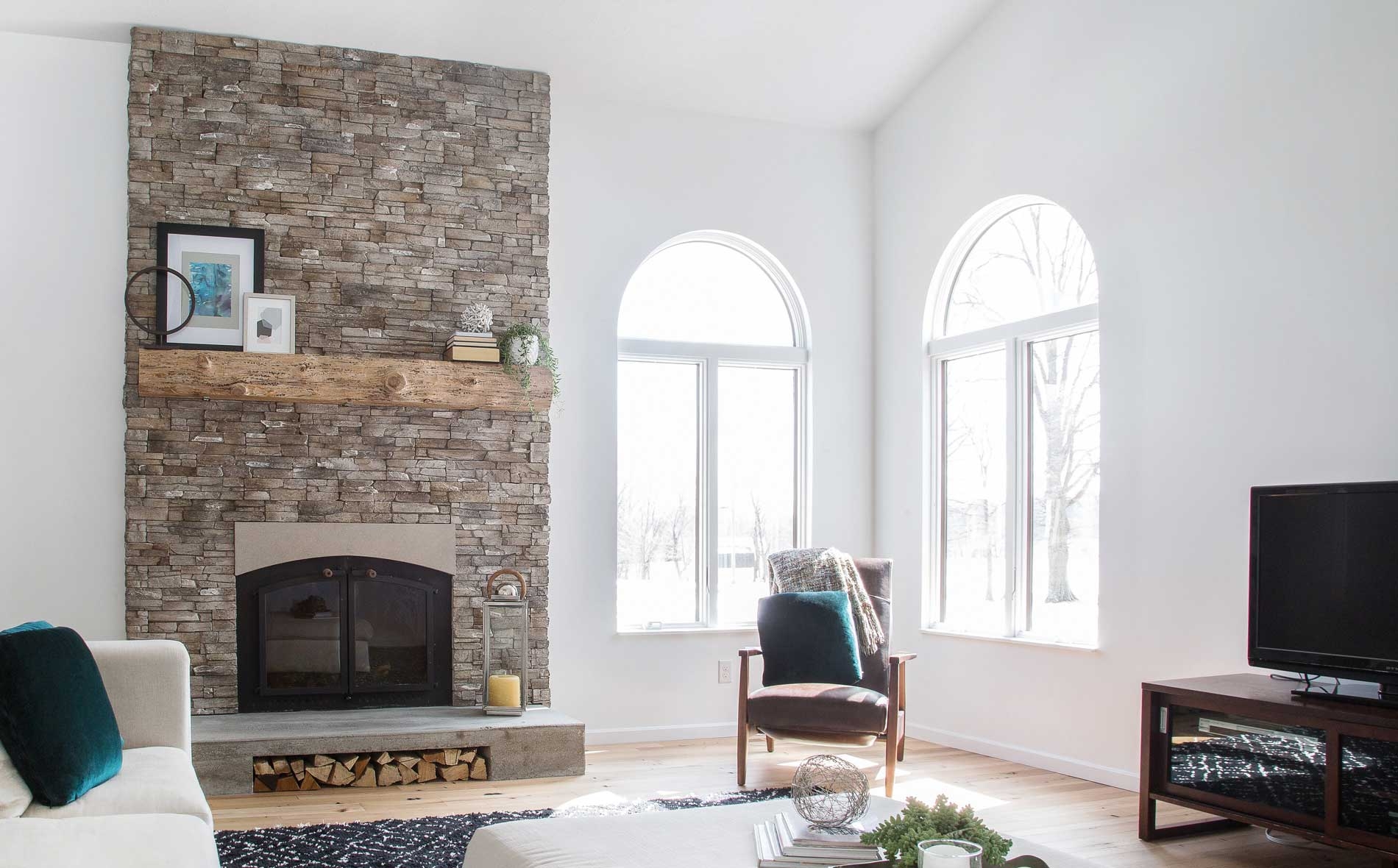 Stone Fireplace Arched View Windows and Rustic Beam Mantel